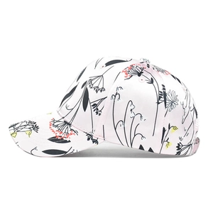 Detailed view of floral print and fine stitching on the pink and white baseball cap