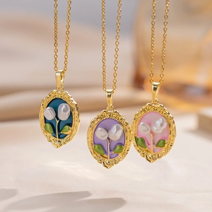 Close-up of baroque freshwater pearl pendants with enamel floral relief in multiple colors