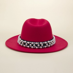 Detail of red wool fedora featuring a black band embellished with white pearls
