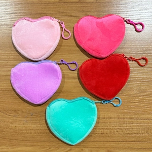 Flat lay of colorful heart-shaped plush coin purses with matching plastic lobster clasps