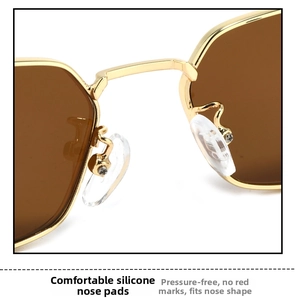 Macro detail of comfortable silicone nose pads and sturdy gold metal frame on sunglasses