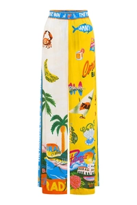 Detail of tropical print wide-leg trousers with palm trees and ocean motifs