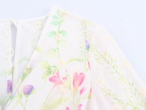 Detail of embroidered floral texture and sheer white fabric on high-waist French dress