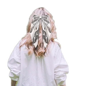 Elegant silver metallic bow hair clip with long ribbons on blonde hair for party