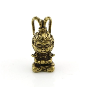 Macro detail of bronze Monkey King figurine with antique finish and fine engravings