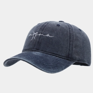 Detail of navy washed denim baseball cap with bow embroidery and vintage stitching