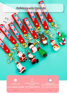 Close-up of assorted PVC Christmas keychains featuring Santa Claus and reindeer characters