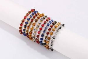 Detailed close-up of natural colorful stone bead bracelets with gold spacer accents