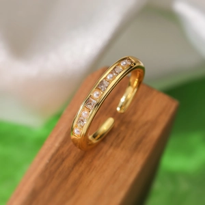Close-up of 18K gold plated ring featuring row-set pearls and square zircon stones