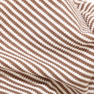 Macro detail of the brown and white striped knit fabric showing texture and soft material