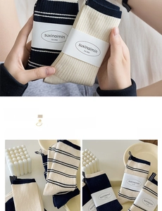 Detailed knit texture of cotton striped socks with branding tag and paper packaging