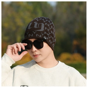 Close-up of winter knit beanie with warm fleece lining and NY monogram pattern