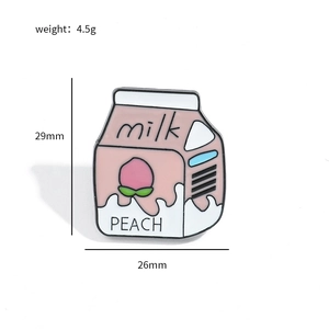 Detail view of pink peach milk carton enamel pin showing size dimensions 29mm and 26mm