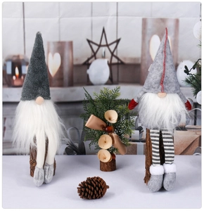 Close-up of plush Christmas gnomes with long striped legs and wooden base decoration