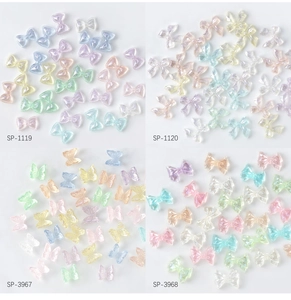 Flat lay of colorful aurora bow resin nail art charms in four-grid professional layout