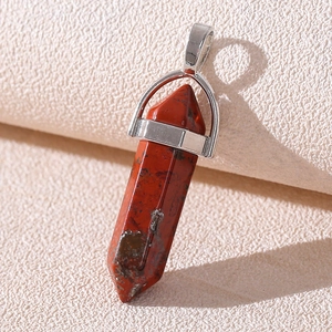 Macro view of a hexagonal red jasper point pendant with a silver metal clasp connector