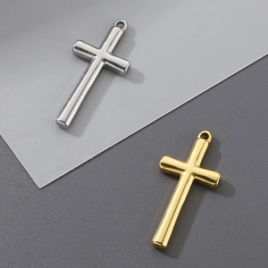 Detail of silver and gold stainless steel cross pendants with polished metallic finish