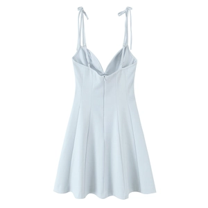 Close-up of light blue floral poplin dress back featuring adjustable bow straps and zipper