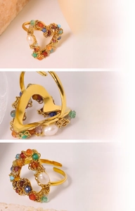 Detail of handmade 18K gold plated heart ring with natural pearl and colorful stones