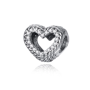Macro shot of silver plated heart bead with sparkling cubic zirconia stones and rope texture