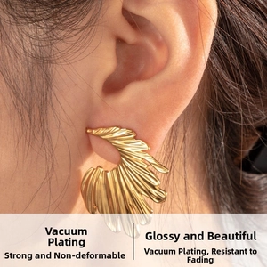Macro shot of vintage style gold floral statement earrings with pleated metal textures
