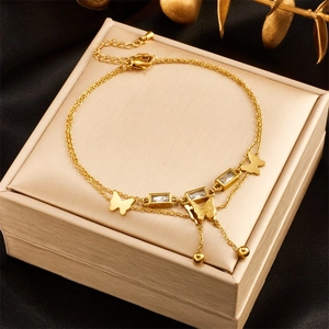 Double-layered gold butterfly bracelet with crystal pendant on luxury silk and gold gift box