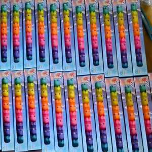 Bulk display of colorful animal-shaped highlighters and stackable toy sets for children