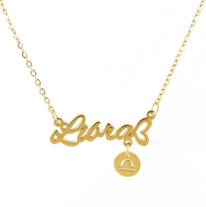 Macro shot of 18k gold Libra constellation pendant with engraved zodiac symbol on chain