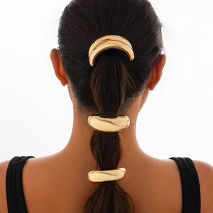 Detail of gold metal minimalist hair accessories on styled model hair