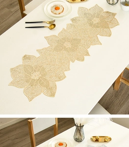 Detail of gold floral hollowed-out PVC table runner with waterproof heat-resistant texture