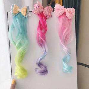 Detailed view of colorful sequin bow hair clips with gradient curly synthetic hair extensions
