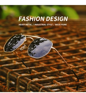 Close-up of polarized aviator sunglasses with gold frames on industrial metal mesh