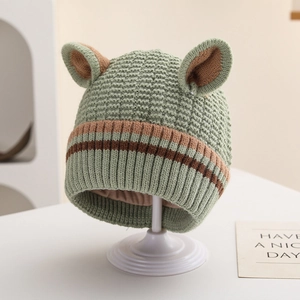 Detail of green knitted toddler hat featuring striped brim and cute 3D animal ears