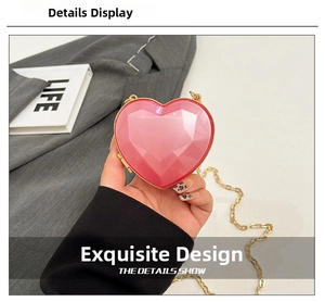Detailed view of a pink heart-shaped mini bag with faceted gemstone texture and gold chain