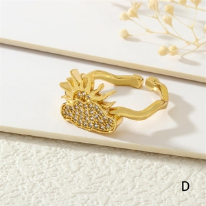 Detail of 18K gold-plated open ring with sun and zircon-pave cloud on a wavy band