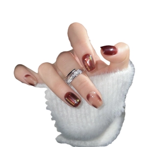 Handmade burgundy and amber press-on nails with golden stripes and cat-eye effect