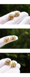 Detailed macro view of blue crystal flower earrings with gold petals and clear zircon stones