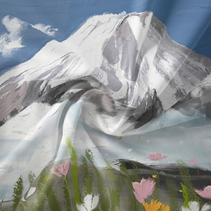 Close-up of translucent bohemian tapestry fabric with snow mountain and floral print