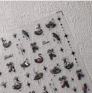 Detail of holographic black swan and ballet nail stickers with a laser finish
