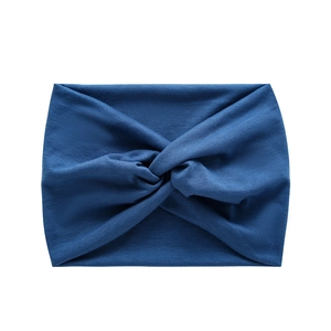 Detail of navy blue wide twisted yoga headband made from elastic knitted fabric material