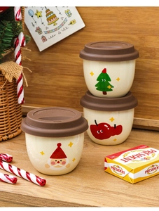 Three festive Christmas ceramic mugs with silicone lids featuring holiday patterns on wood