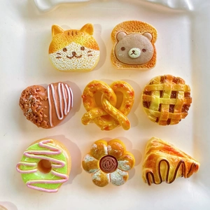Macro shot of 8 assorted resin miniature food charms including cat bread and bear toast