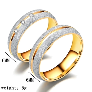 Detail of 6mm two-tone titanium steel rings with brushed silver finish and gold plating