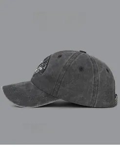 Close-up of vintage washed baseball cap featuring detailed 85 embroidery and worn edges