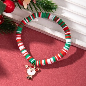 Close-up of Christmas beaded bracelet with Santa Claus pendant and festive decor