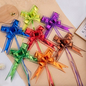 Close-up of seven colorful metallic pull bows for gift wrapping and holiday decoration