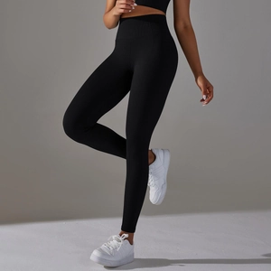Detail of high-waist black yoga pants featuring honeycomb textured compression fabric
