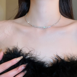 Close-up of a silver choker necklace featuring a row of sparkling rhinestones on model
