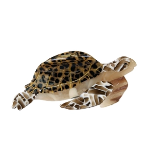 Turtle-shaped acetate hair claw clip with tortoise shell pattern on white background