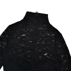 Detail of high neck design and back zipper closure on black lace textured fabric